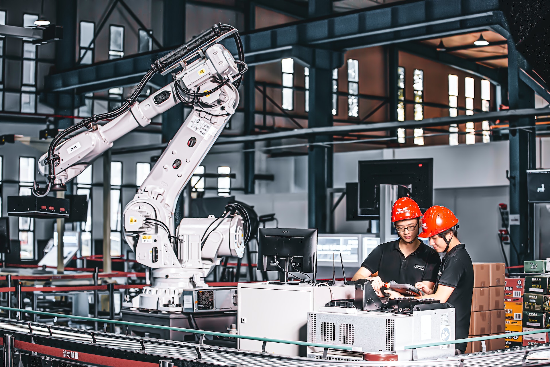 Two people in a factory looking at a tablet