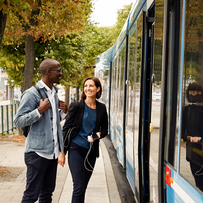 Un homme noir et une femme blanche debout devant un tramway